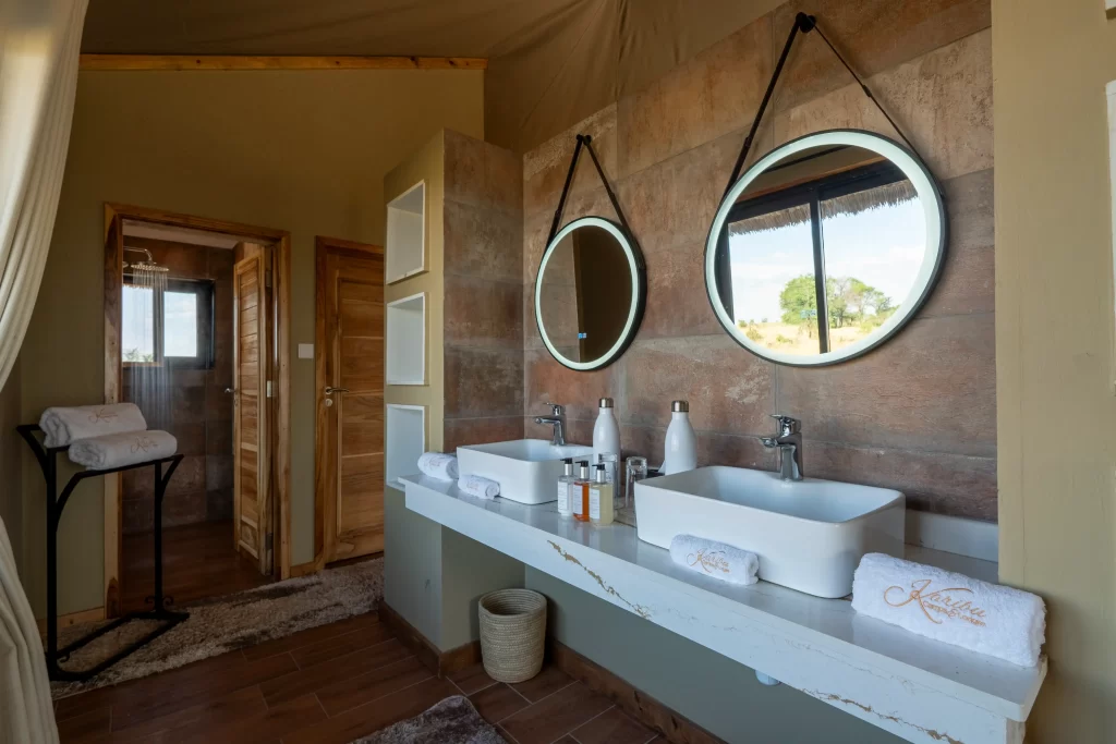 inside a double room at river camp by karibu camps - perfect bathroom